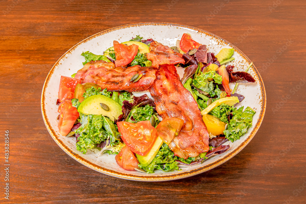 Lettuce salad, fried bacon, avocado and pumpkin seeds, tomato and oil and vinegar Lettuce salad, fried bacon, avocado and pumpkin seeds, tomato and oil and vinegar