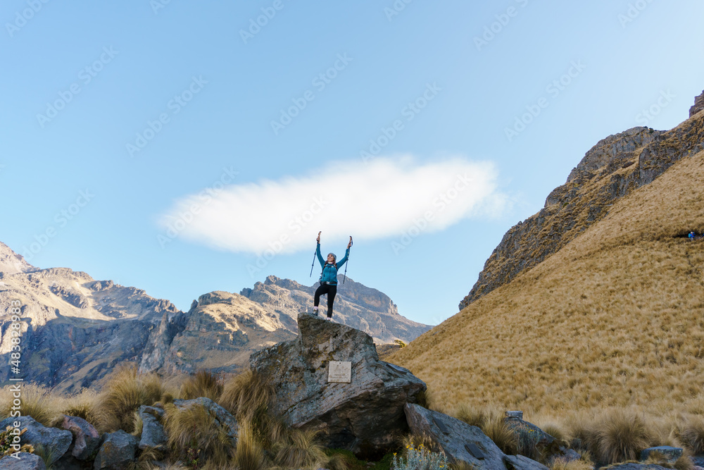 woman hiker open arms at mountain top cliff edge woman hiker open arms at mountain top cliff edge