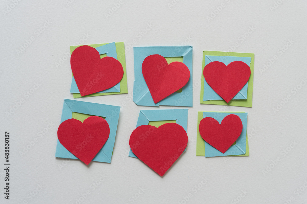 six red paper hearts 