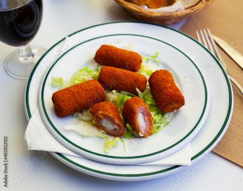 Spanish flamenquines, breaded pork loin rolled with serrano ham, typical of Andalusia photo