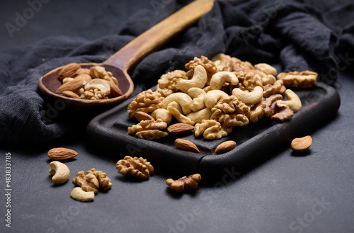 walnut, almond, cashew on a wooden board. Delicious nutritious snack