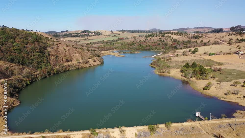 Pocos de Caldas Minas Gerais Brazil. Scenic lake with dry forest trees at edge of lake at end of winter. Great dry landscape at end of winter at rural life. Winter at rural landscape beautiful lake.