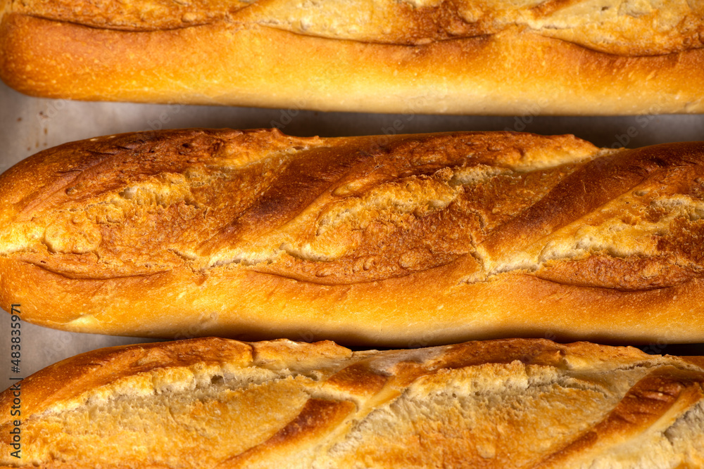 A closeup background of smaller French bread baguettes.