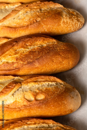 A closeup background of smaller French bread baguettes.