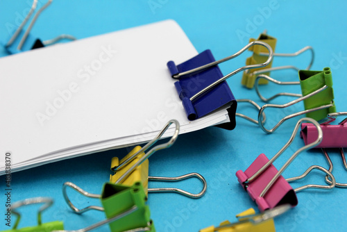 colored clips on a blue background. photo
