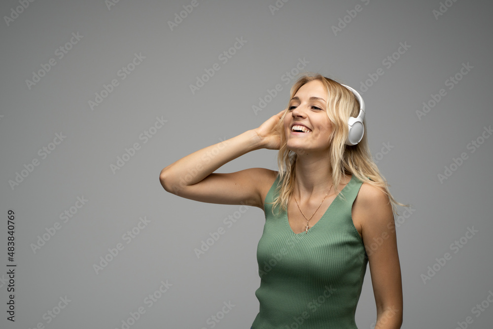 Young beautiful woman in green t-shirt enjoying a music. Young beautiful woman in green t-shirt enjoying a music.