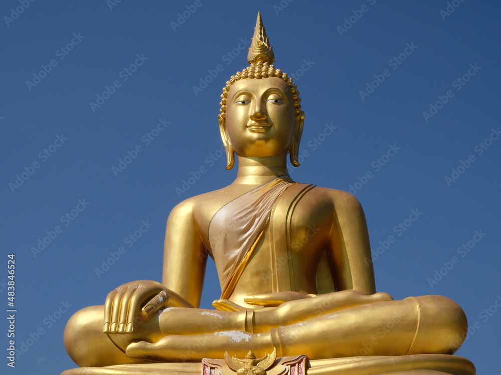 Golden Buddha Statue soars into blue sky Golden Buddha Statue soars into blue sky