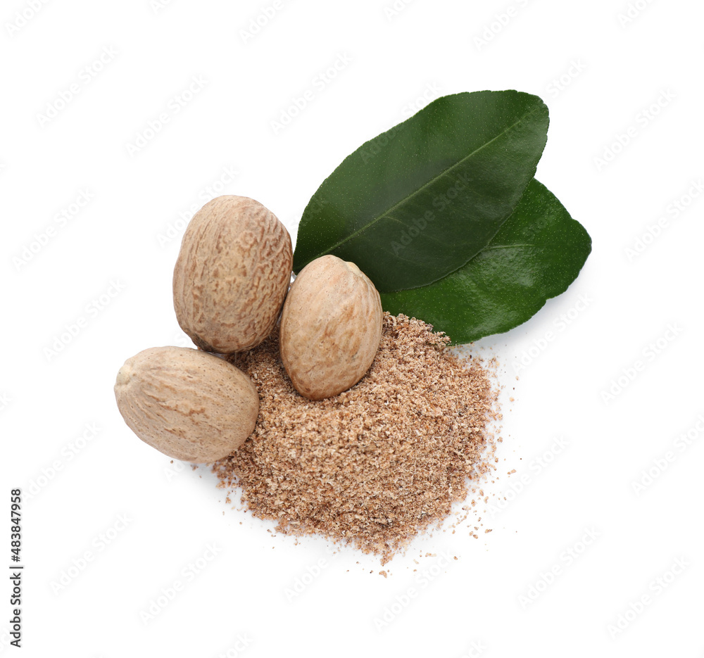 Nutmeg powder and seeds with green leaves on white background, top view Nutmeg powder and seeds with green leaves on white background, top view