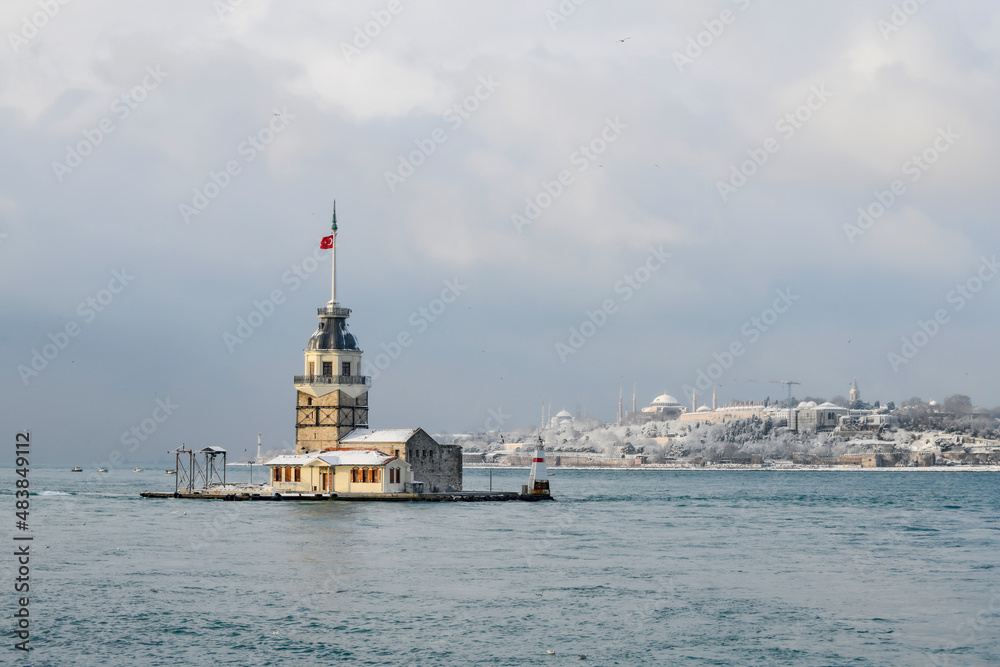 Magnific view of Maiden's Tower (aka Kiz kulesi) in winter day with many snow in Istanbul,Turkey. Istanbul's main attractions. 