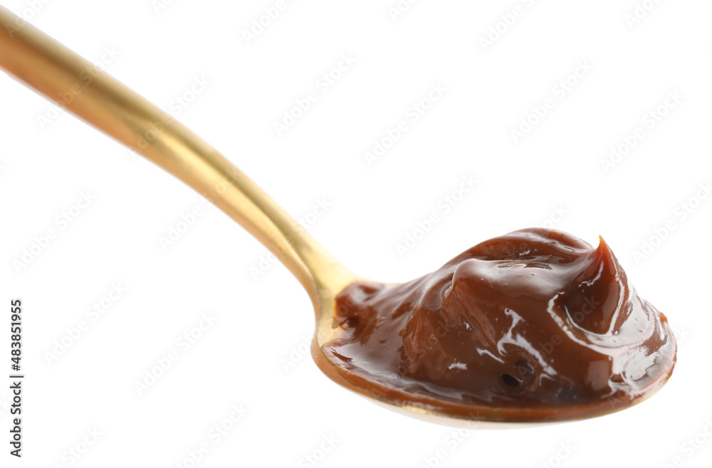 Spoon with tasty boiled condensed milk isolated on white Spoon with tasty boiled condensed milk isolated on white