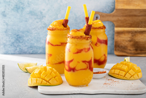 Mangonada mexican mango smoothie with chamoy sauce and lime seasoning photo