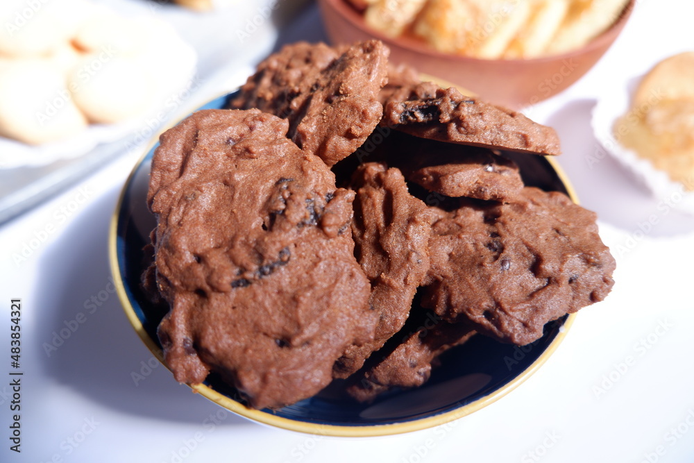 homemade chocolate cookies in a bowl, on a gray background. snacks, biscuits, made from flour, eggs, and sugar are eaten at tea time. snack time. close up homemade chocolate cookies in a bowl, on a gray background. snacks, biscuits, made from flour, eggs, and sugar are eaten at tea time. snack time. close up