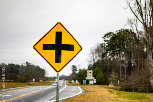 Yellow 4 way intersection road sign 