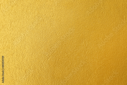 Gold wall texture abstract background, plastered wall painted gold color