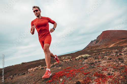 Running marathon man runner sport athlete training ultra running on long distance endurance trail race wearing compression clothes, sunglasses smartwatch wearable device