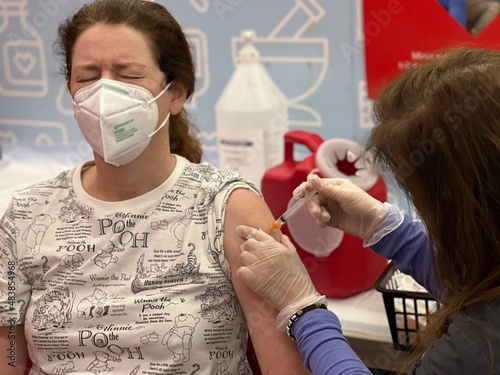 Woman being inoculated against virus's photo