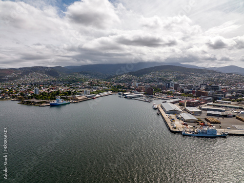 High angle aerial drone view of Sullivans Cove, the harbour area of Hobart, capital of the island state of Tasmania, Australia. Mount Wellington in the background is covered in clouds.	 photo