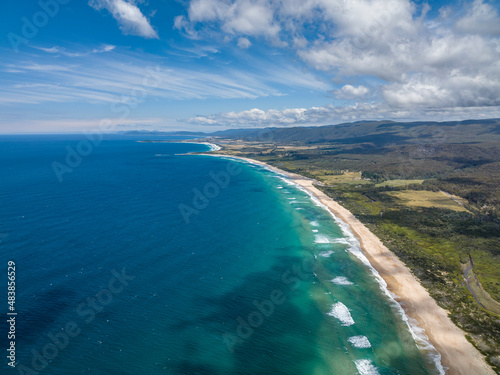 Stunning high angle aerial panoramic drone view of Lagoons Beach Conservation Area and the A3 Tasman Highway near the village of Scamander on the east coast of Tasmania  Australia on a sunny day.