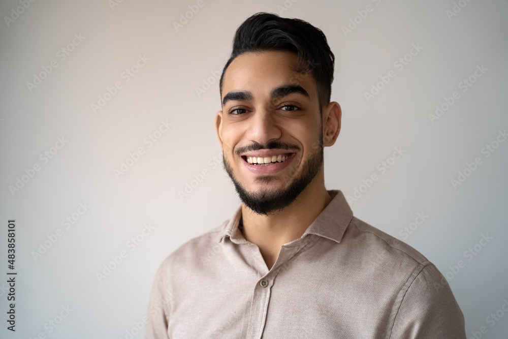 Headshot portrait of young adult smiling Indian man over blank copy space Headshot portrait of young adult smiling Indian man over blank copy space
