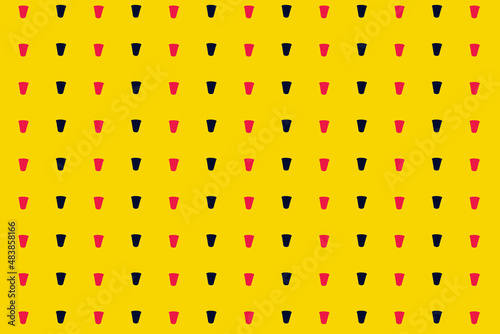 Colorful pattern of pink and black paper drinking cups on yellow background. Top view. Flat lay. Pop art design