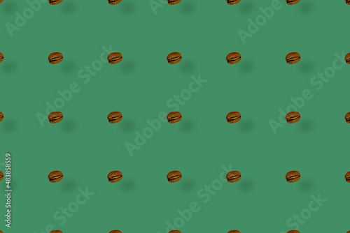 Colorful pattern of coffee beans on green background with shadows. Top view. Flat lay. Pop art