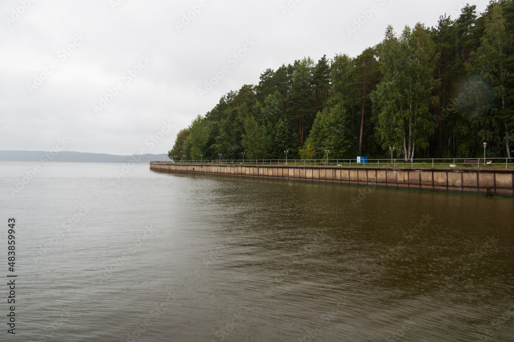 old embankment by the river, outdoor recreation near the water, cloudy morning, landscaping