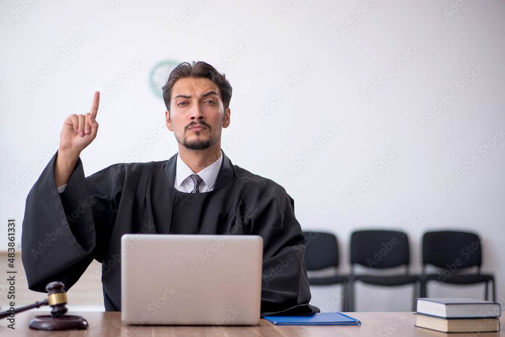 Young male judge working in the courthouse Young male judge working in the courthouse