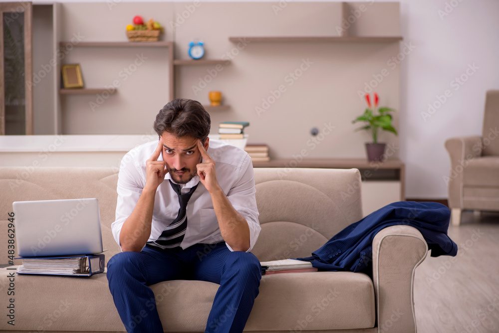 Young male employee working from home during pandemic Young male employee working from home during pandemic
