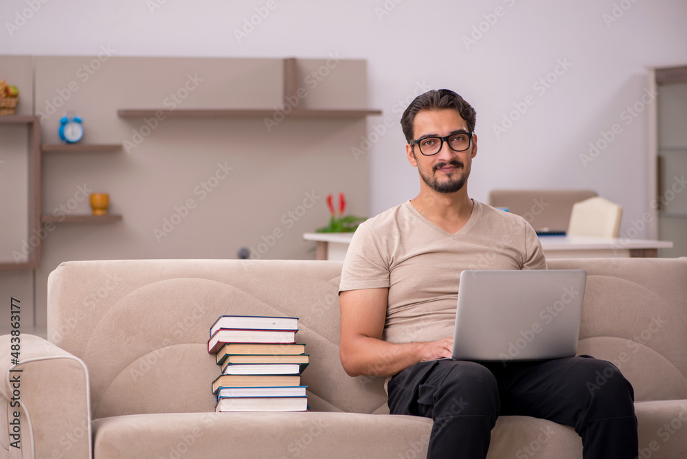 Young male student studying at home during pandemic Young male student studying at home during pandemic