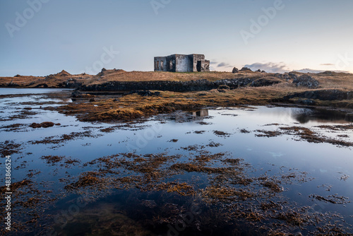 An abandoned building on the south coast of Iceland near the town of Grindavik at sunset.