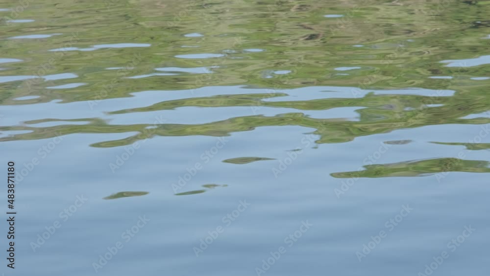 View from boat of Sunlight at sunrise reflected in the lake with water ripple on a winter morning. View from boat of Sunlight at sunrise reflected in the lake with water ripple on a winter morning.