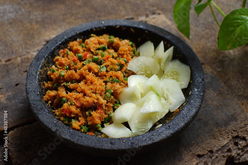 a plate of  traditional food named sambal urap  that made from fresh coconut grated with ground raw spices  photo