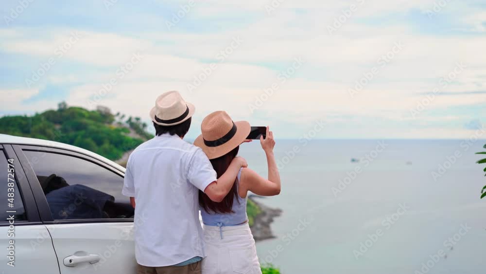 Young couple traveler looking at the beautiful sea view with their car while travel driving road trip on vacation Young couple traveler looking at the beautiful sea view with their car while travel driving road trip on vacation
