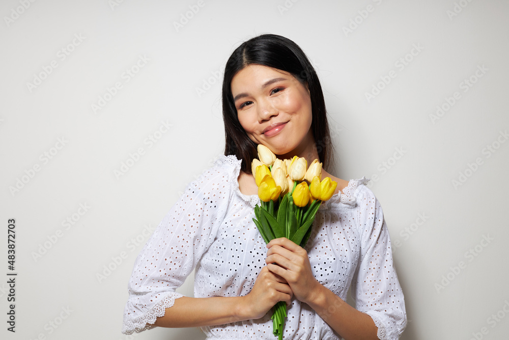 woman in a white shirt flowers spring posing light background unaltered woman in a white shirt flowers spring posing light background unaltered
