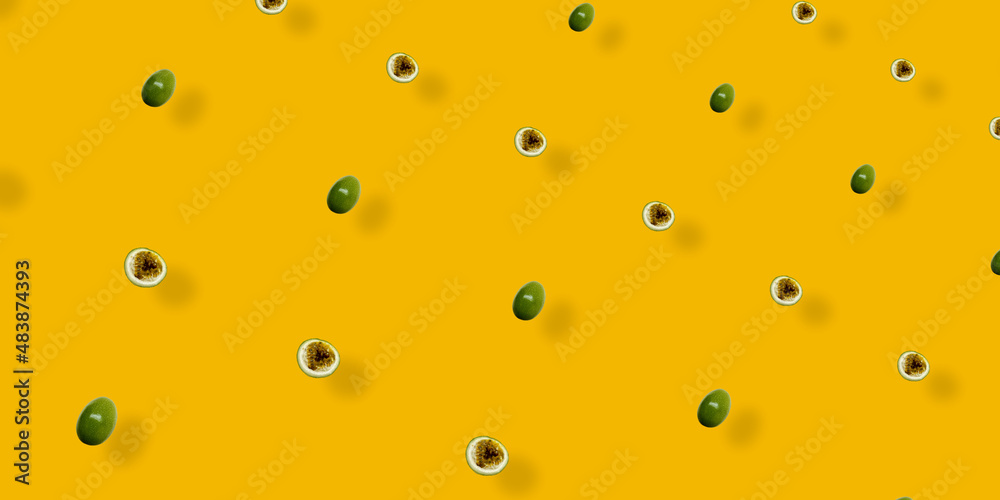 Colorful fruit pattern of fresh passion fruit on orange background with shadows. Top view. Flat lay. Pop art design Colorful fruit pattern of fresh passion fruit on orange background with shadows. Top view. Flat lay. Pop art design