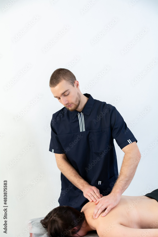 physiotherapist treats the patient. sports massage physiotherapist treats the patient. sports massage