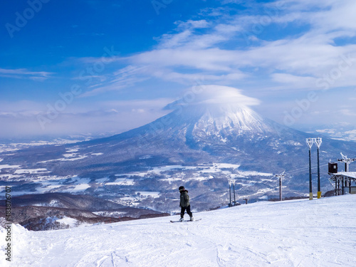 Snowy volcano with cap cloud viewed from a ski resort (Niseko Hanazono Resort, Hokkaido, Japan)