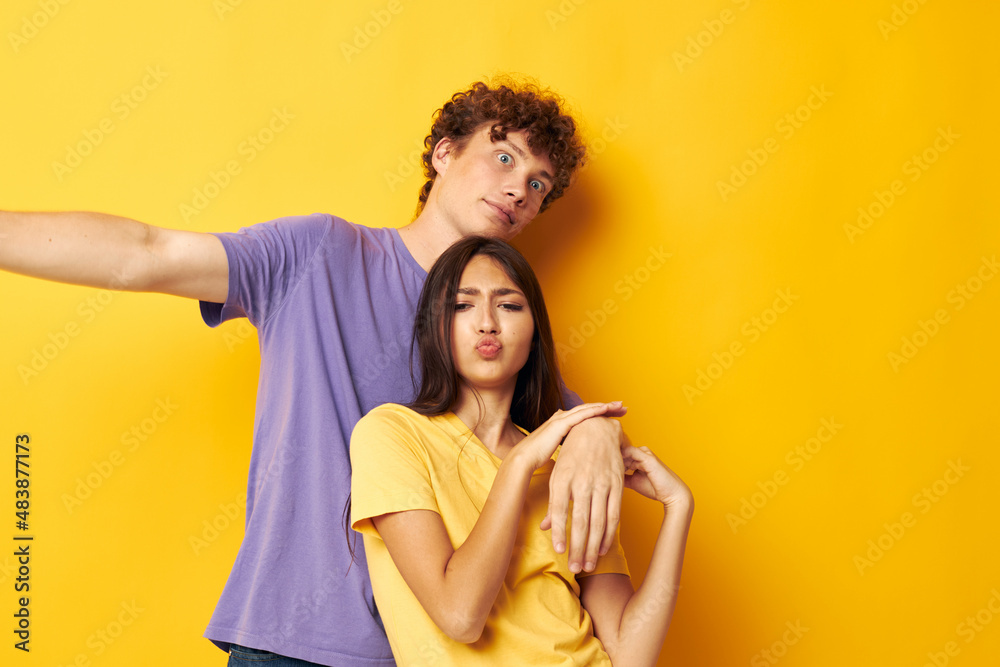 cute young couple in colorful t-shirts posing friendship fun isolated background unaltered
