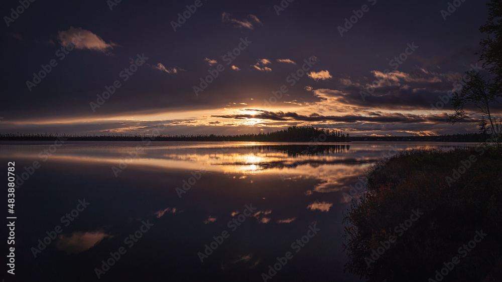 A majestic sunset reflecting on a lake near Talkeetna, Anchorage, Alaska