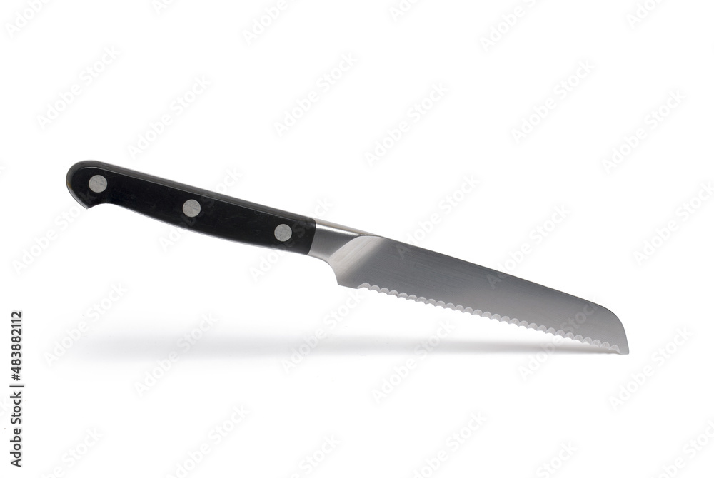 Closeup bread knife serrated blade white background Closeup bread knife serrated blade white background