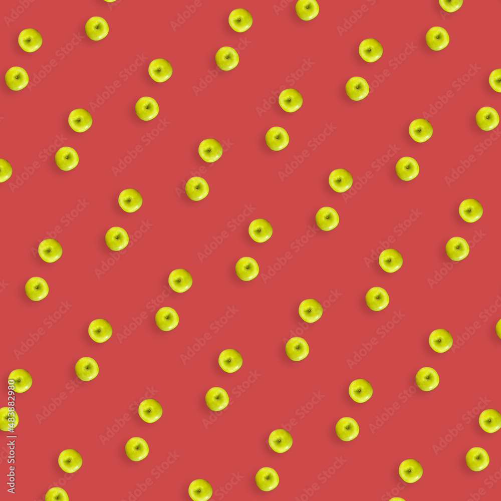 Colorful fruit pattern of fresh green apples on red background. Top view. Flat lay. Pop art design, creative summer concept Colorful fruit pattern of fresh green apples on red background. Top view. Flat lay. Pop art design, creative summer concept
