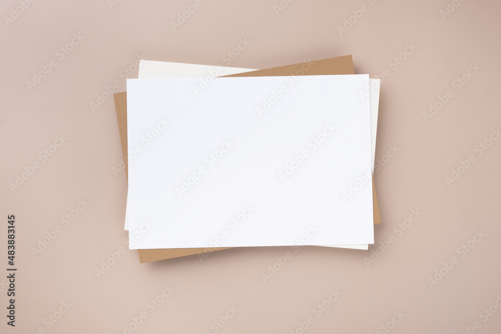 Minimal paper card mockup on beige background. Flat lay, top view Minimal paper card mockup on beige background. Flat lay, top view