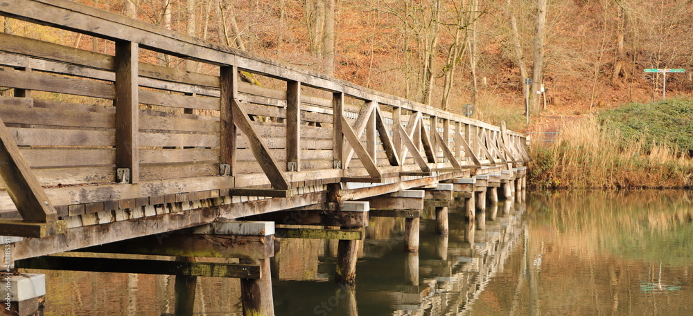 an old wooden bridge over a lake an old wooden bridge over a lake