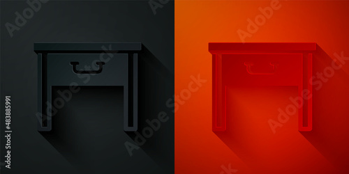 Paper cut Furniture nightstand icon isolated on black and red background. Paper art style. Vector