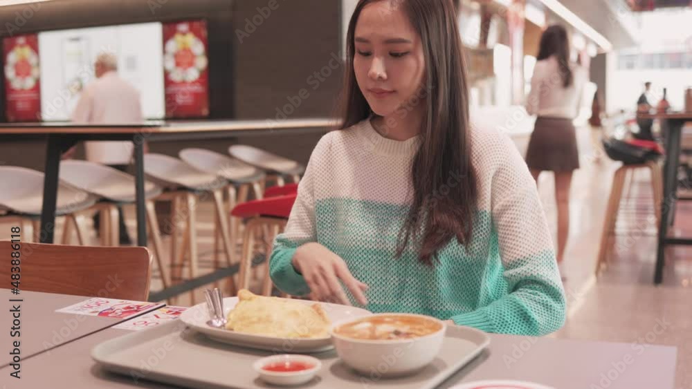 Asian woman sitting separated in restaurant eating food .keep social distance for protect infection from coronavirus covid-19, restaurant and social distancing concept. Asian woman sitting separated in restaurant eating food .keep social distance for protect infection from coronavirus covid-19, restaurant and social distancing concept.