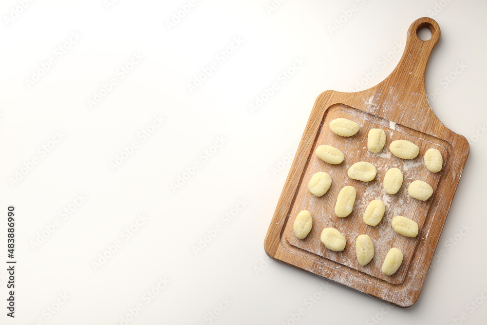 Cutting board with raw potato gnocchi on white background Cutting board with raw potato gnocchi on white background