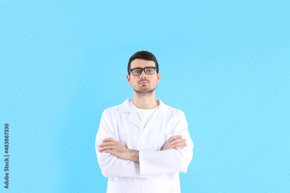 Young man doctor on blue background, healthcare and medicine Young man doctor on blue background, healthcare and medicine