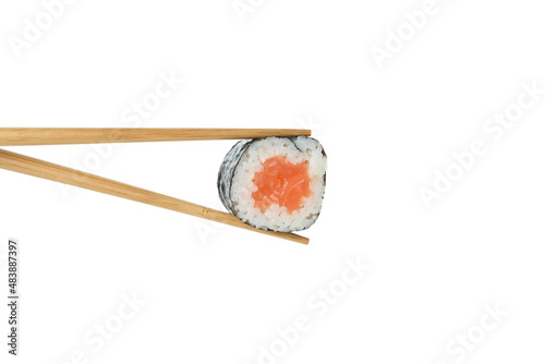 Chopsticks with maki isolated on white background
