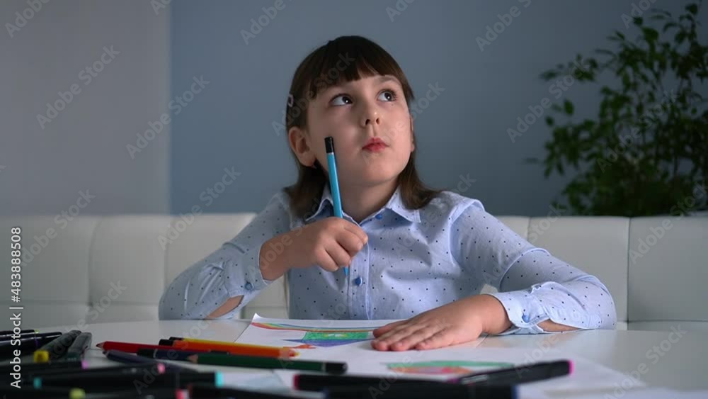 Kids creativity. Child little girl drawing rainbow with colored pencils on paper at home Kids creativity. Child little girl drawing rainbow with colored pencils on paper at home
