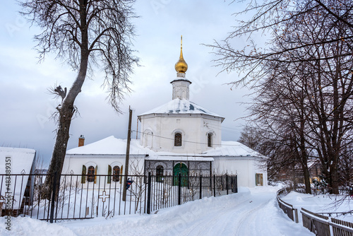 Small rural ancient Orthodox Temple covered with snow.